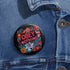 A black round pinback button featuring floral embroidery-style designs and bold red text that reads "Obey Nothing."